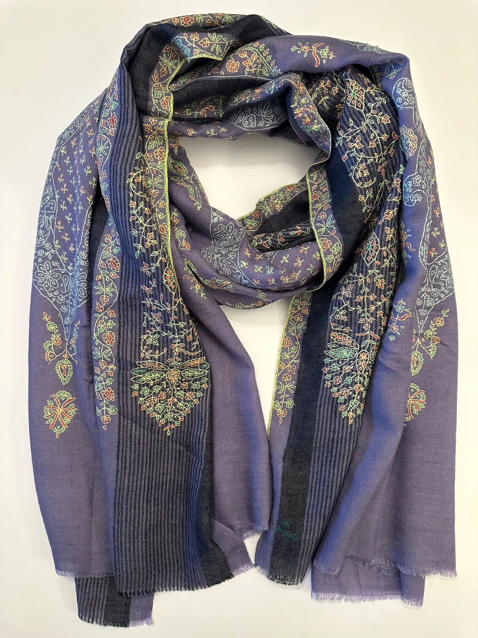 Lavender blue stole with bands of multicoloured needlework and a striped panel.