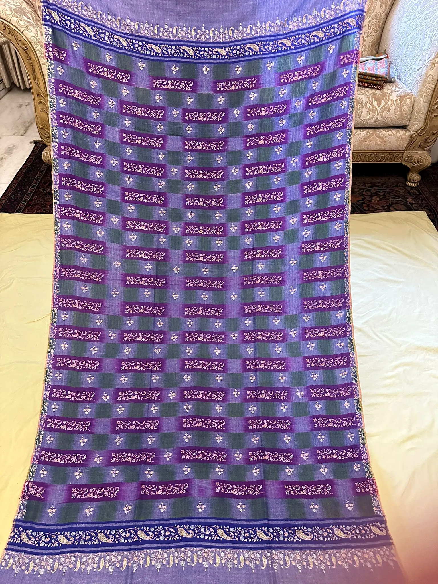 Lilac and purple check shawl with needlework, laid out full length.