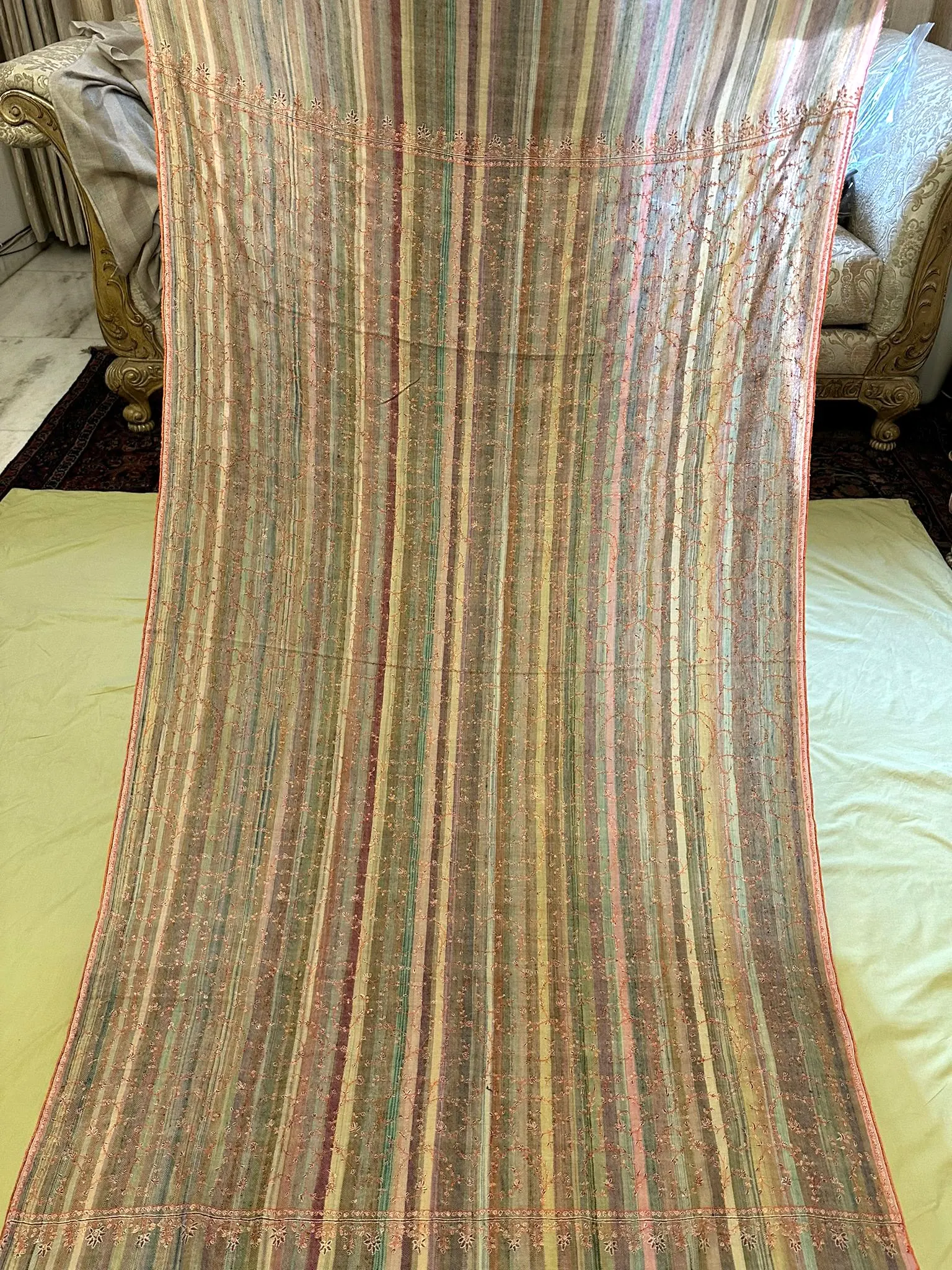 Shawl in fine multicoloured stripes laid out full length.