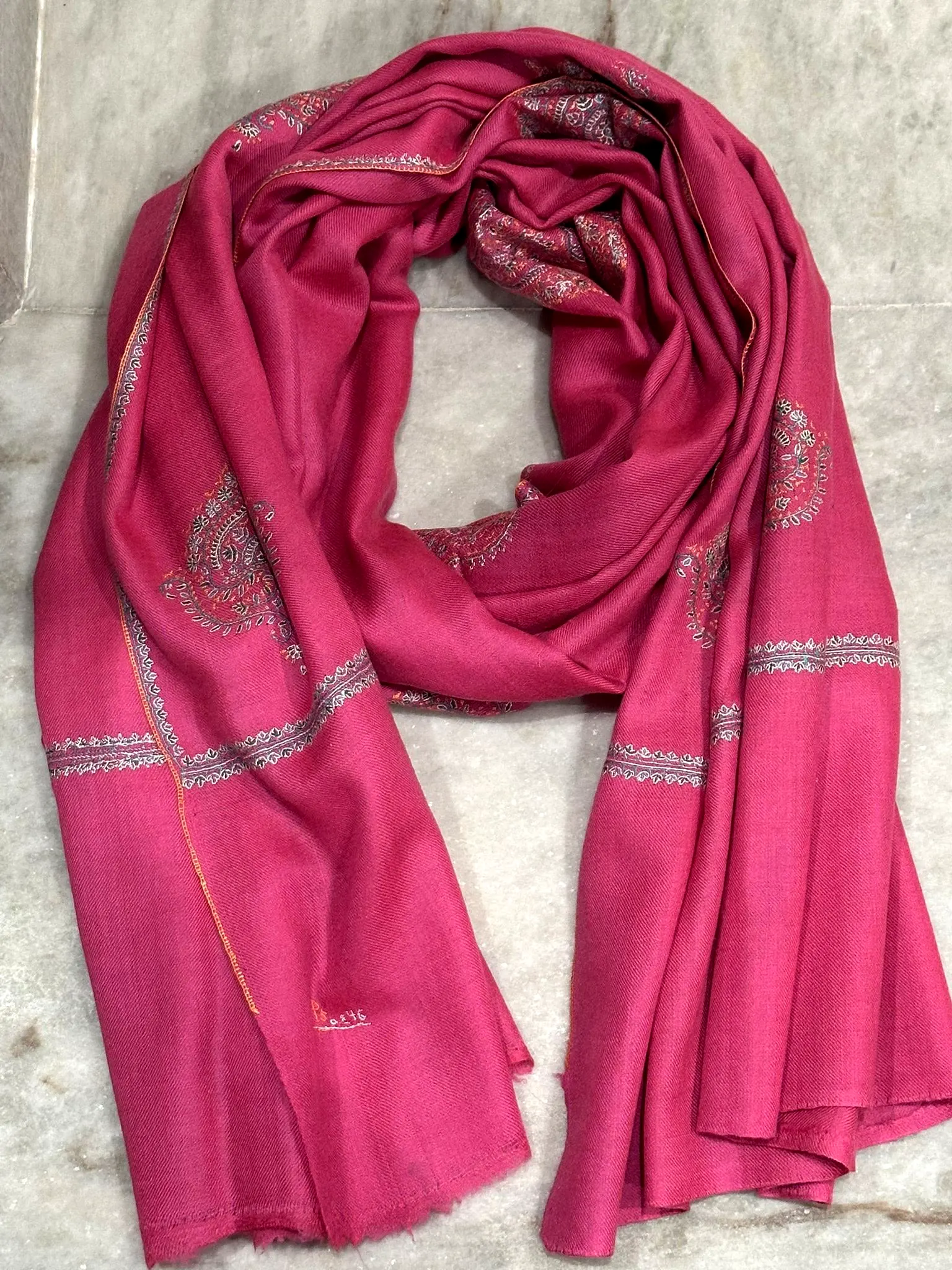 Pink stole with tonal paisley needlework.