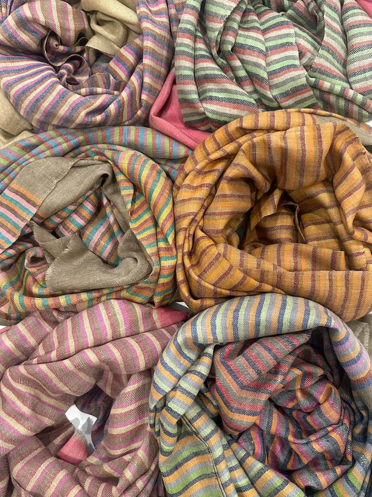 Folded stoles in fine multicoloured stripes.