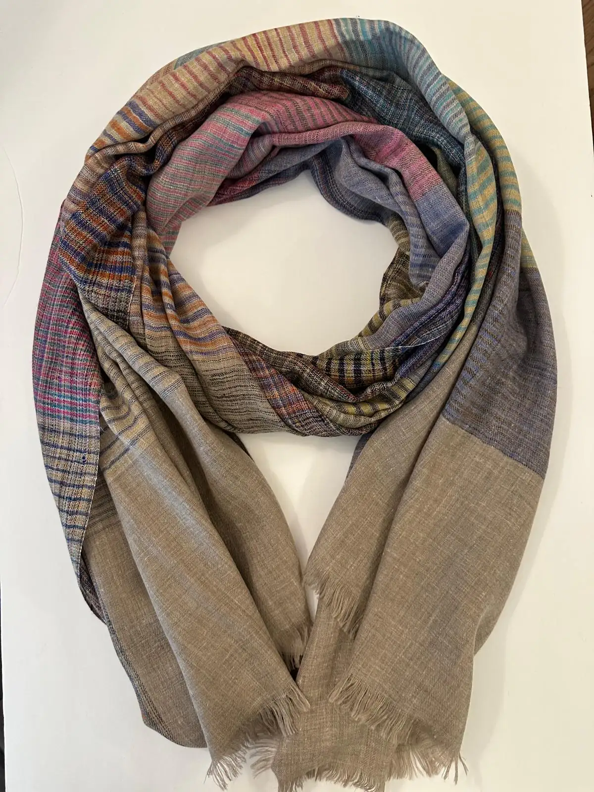 Stole with fine rainbow stripes in pink, blue and gold above a plain taupe body.