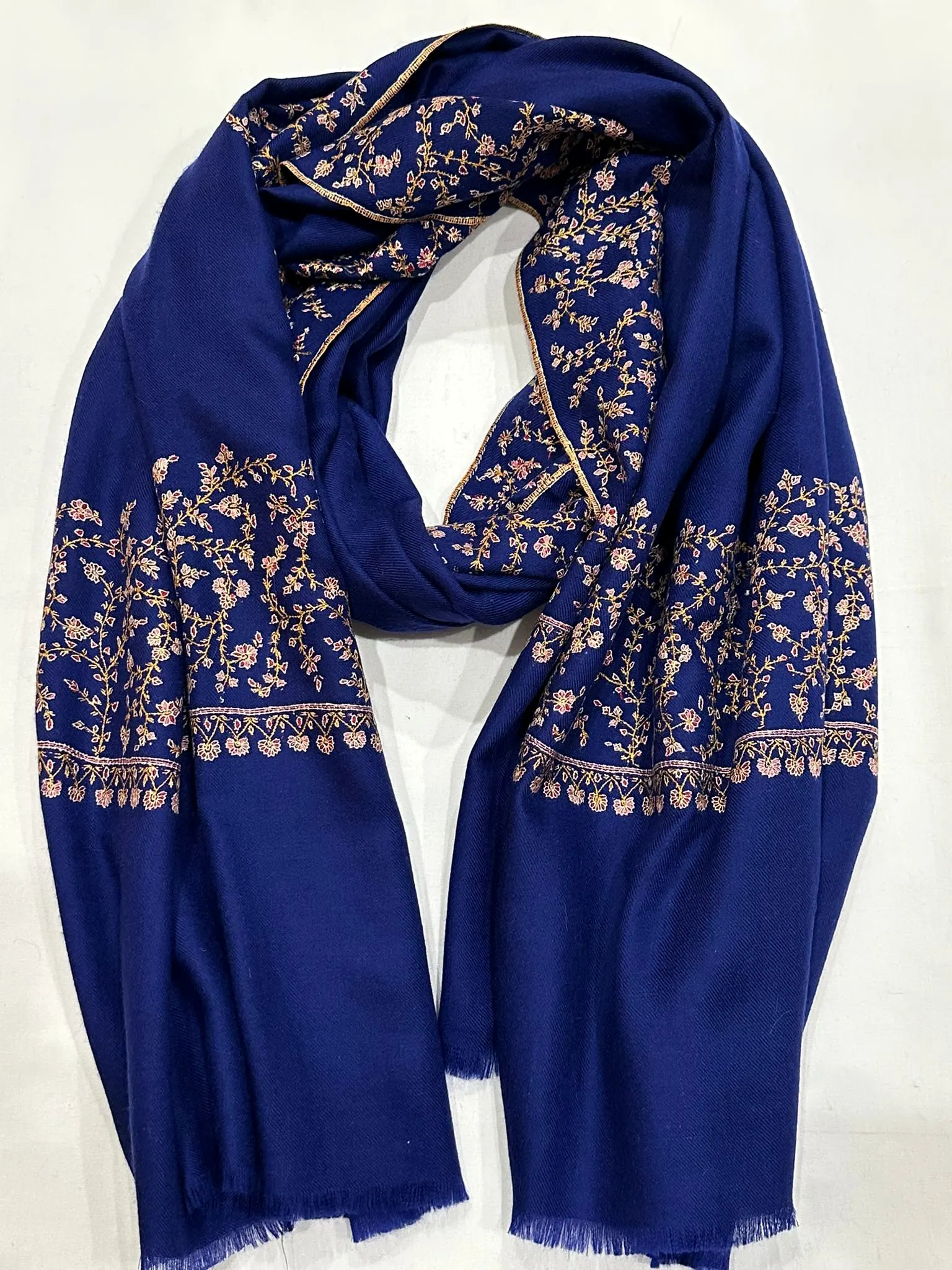 Royal blue stole with ivory and rust needlework borders.