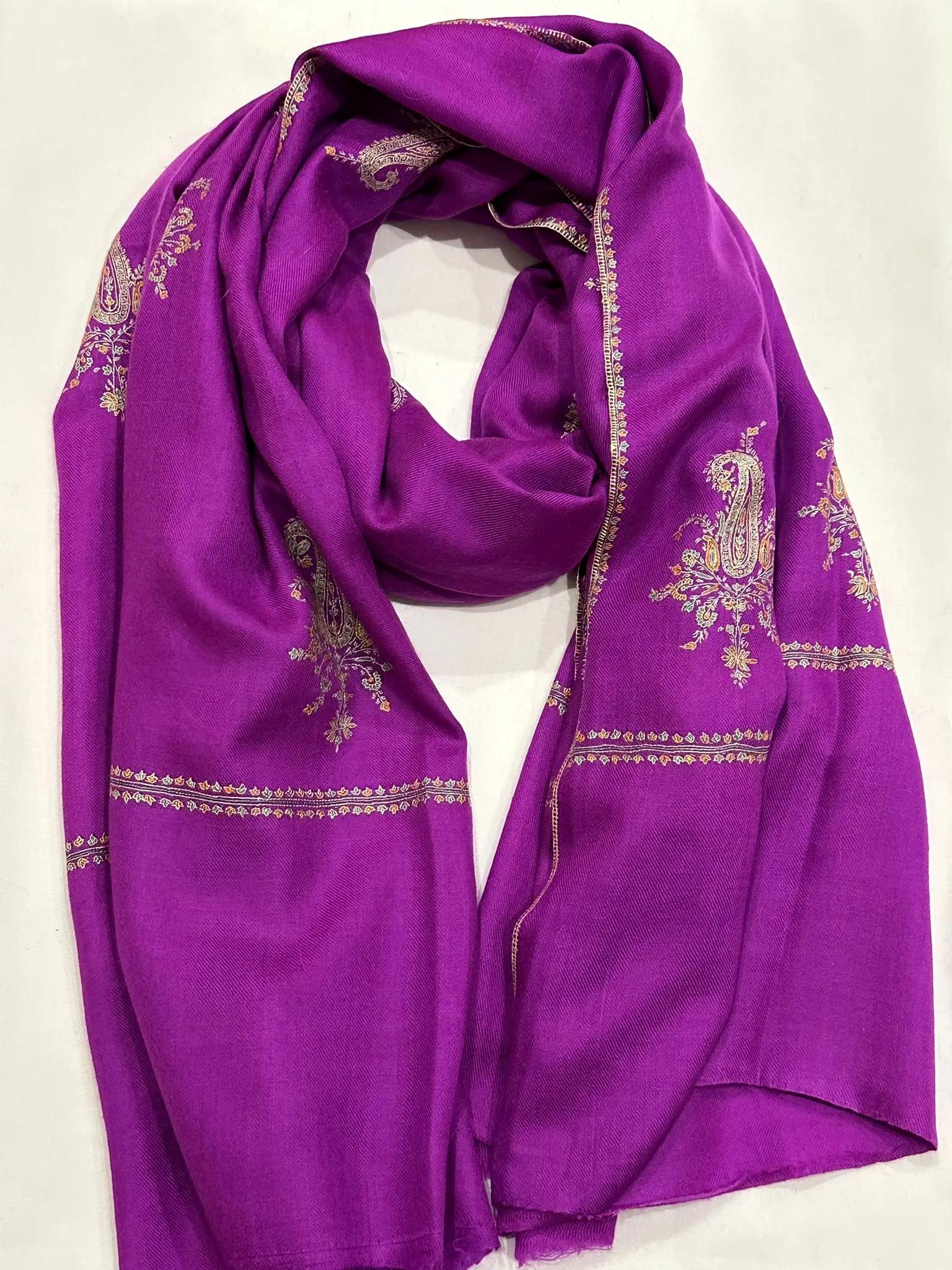Violet stole with ivory and gold needlework motifs and a worked border.